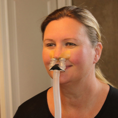 User demonstrating comfortable fit of Bleep Eclipse headgear-free magnetic CPAP mask