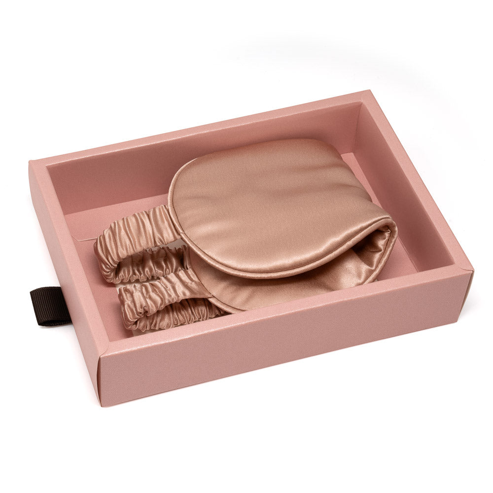 Close-up texture of lustrous pure mulberry silk fabric on Blissy rose gold sleep mask