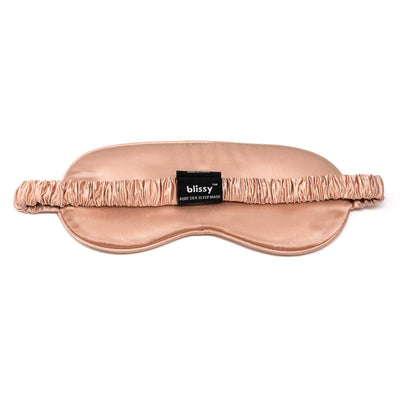 Front view of cushioned Blissy mulberry silk sleep mask in shimmering rose gold