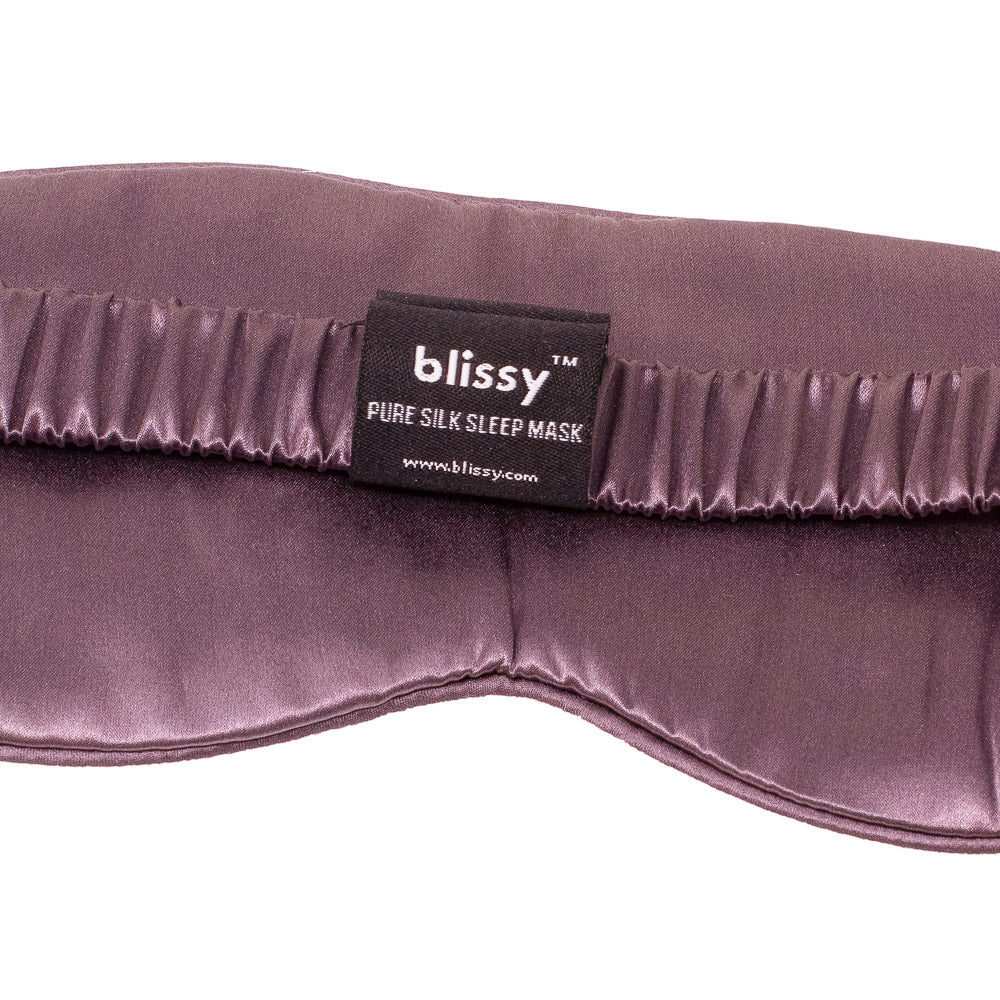 Close-up texture of cushioned pure mulberry silk fabric on Blissy plum sleep mask