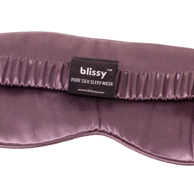 Close-up texture of cushioned pure mulberry silk fabric on Blissy plum sleep mask