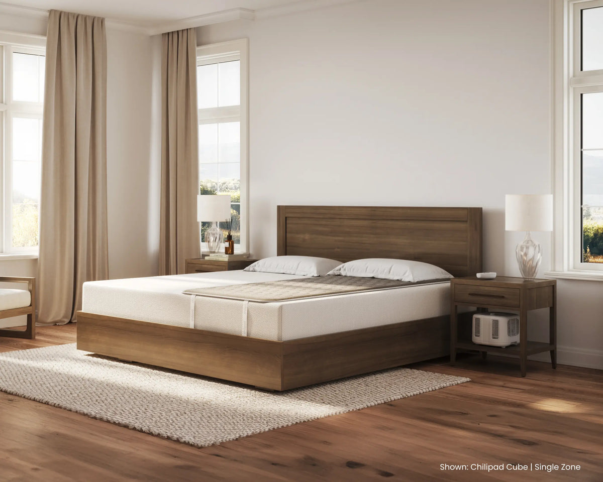 Wooden bed in a bedroom with white bedding and nightstands.