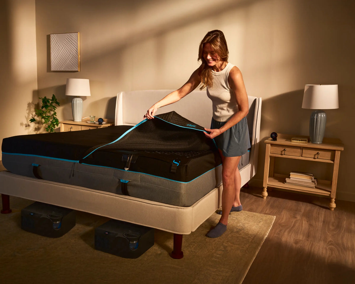 Woman unboxing a new mattress in a bedroom setting