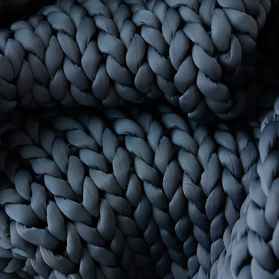 Close-up of cooling open-weave knit loops on Nuzzie Ice Knit blanket in northern grey
