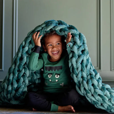 Close-up of luxurious hand-woven velvet yarn loops on Nuzzie emerald weighted blanket