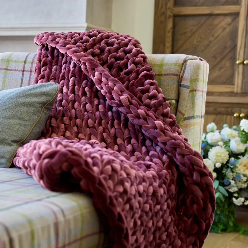 Close-up of rich ruby red velvet woven loops on Nuzzie chunky weighted blanket