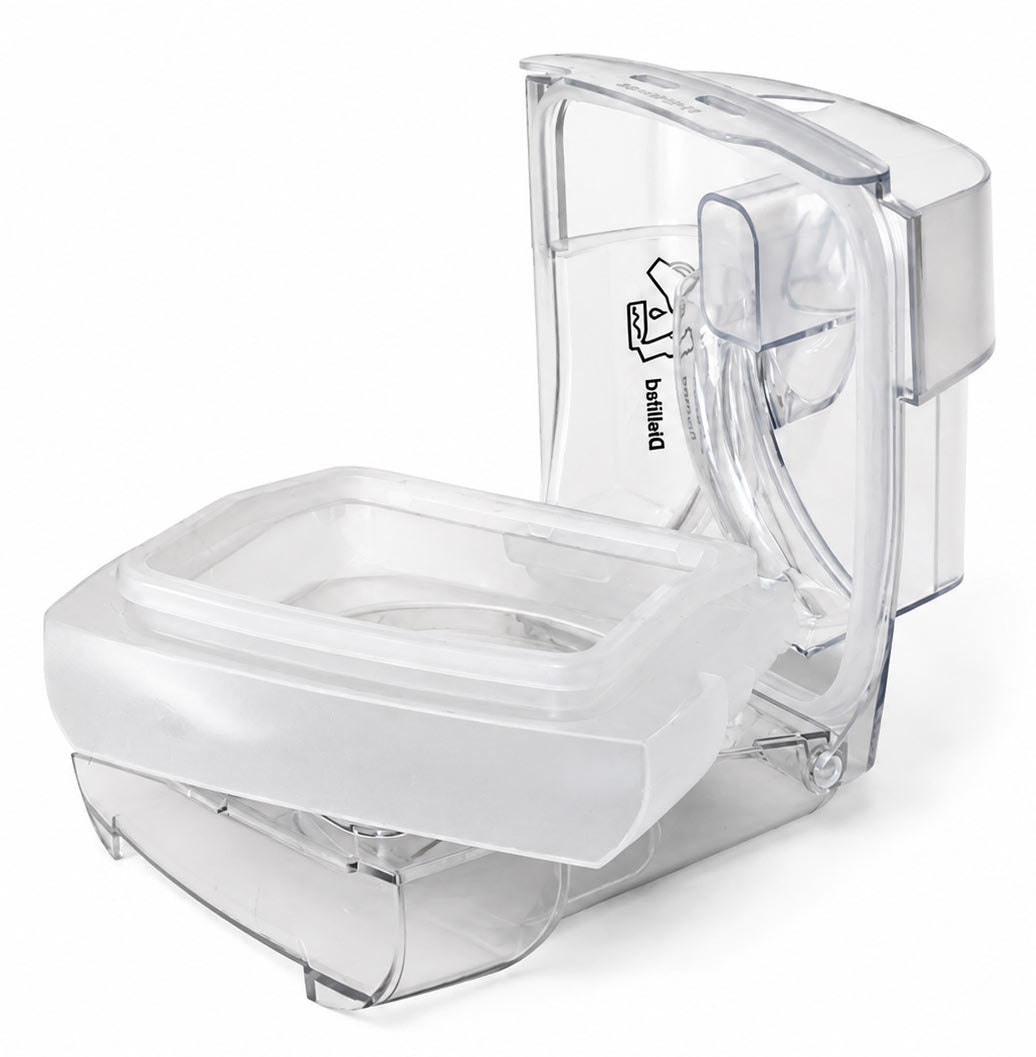 A transparent plastic toilet paper holder or toilet paper dispenser component with a hinged lid, shown on a clean white background.