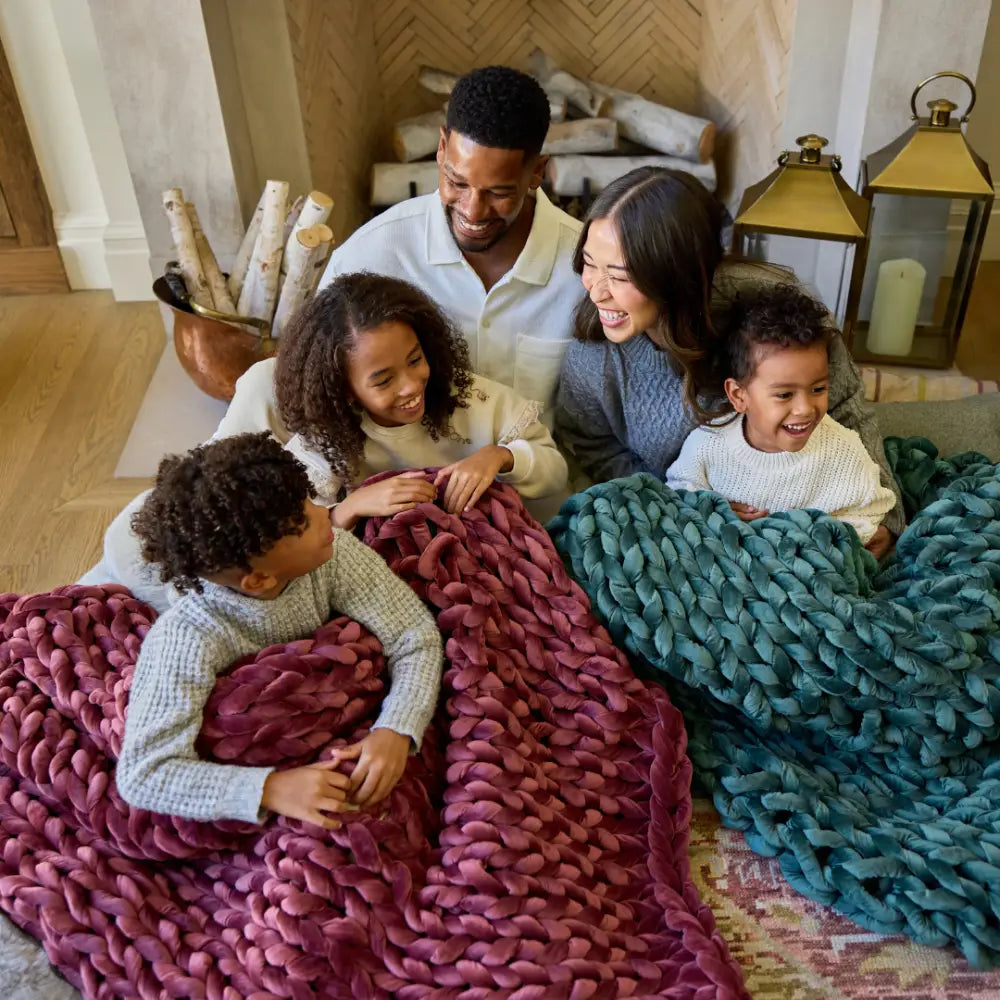 Detailed texture of plush lustrous ruby velvet yarn on Nuzzie hand-knit blanket
