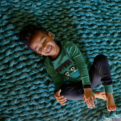 Detailed view of breathable open-loop hand-knit velvet on Nuzzie emerald blanket