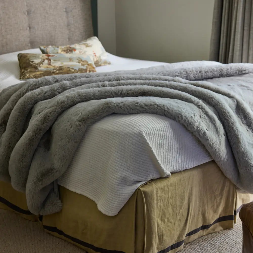 Detailed view of thick hand-knitted chenille loops on Nuzzie Snuggle Luxe earl grey blanket