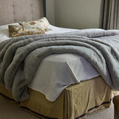 Detailed view of thick hand-knitted chenille loops on Nuzzie Snuggle Luxe earl grey blanket