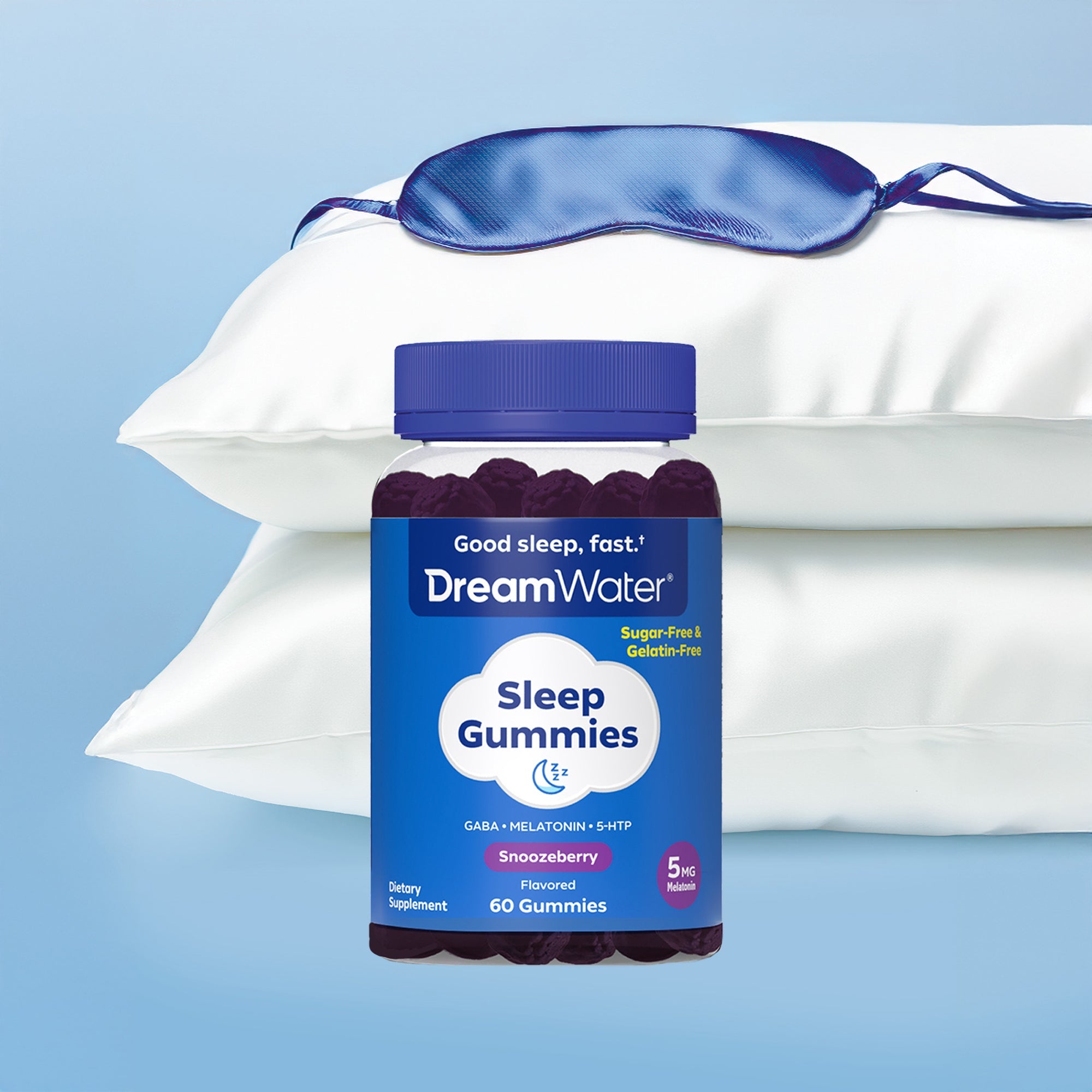 DreamWater Sleep Gummies bottle with a blue sleep mask on white pillows against a light blue background. Sugar-Free & Gelatin-Free.