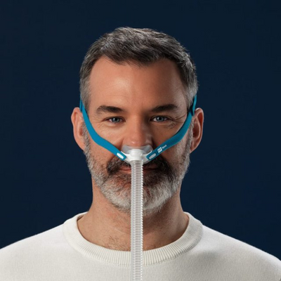 Male CPAP user wearing minimal-contact Fisher & Paykel Nova Micro nasal pillow mask