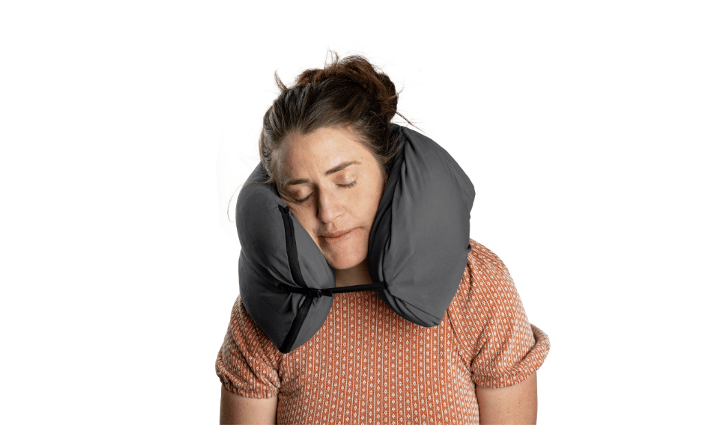 Girl resting comfortably during road trip sleeping on HEST Pro contour travel pillow