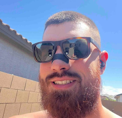 Athletic individual using Hostage Nose Strip outdoors during exercise and breathing support