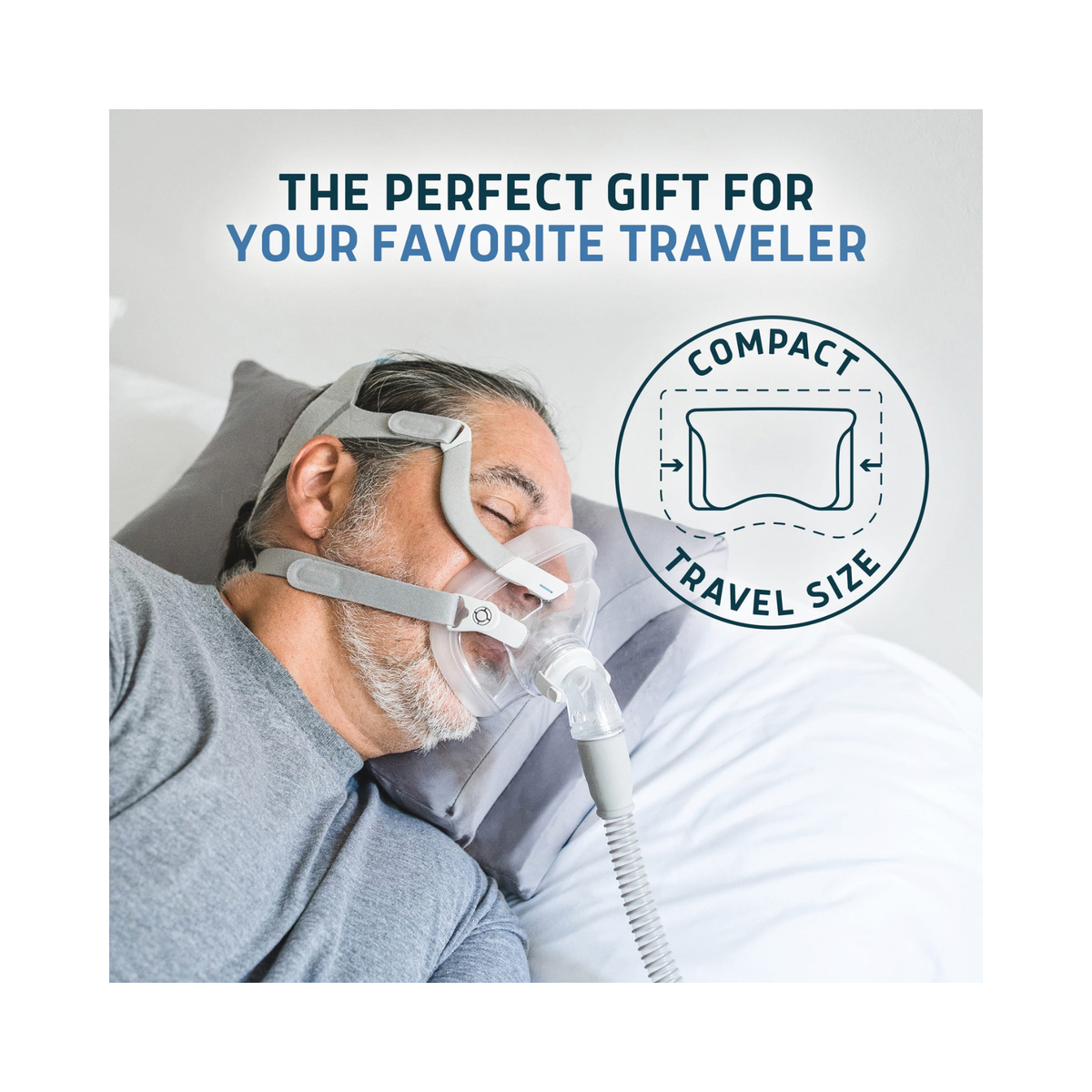 A man wearing a compact travel-size CPAP mask and hose while resting in bed, with promotional text reading 'THE PERFECT GIFT FOR YOUR FAVORITE TRAVELER' and a circular badge labeled 'COMPACT TRAVEL SIZE'.