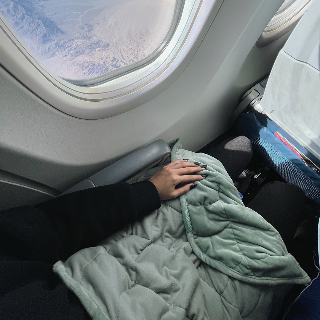 nodpod Body Blanket - Sage on Lap on Plane