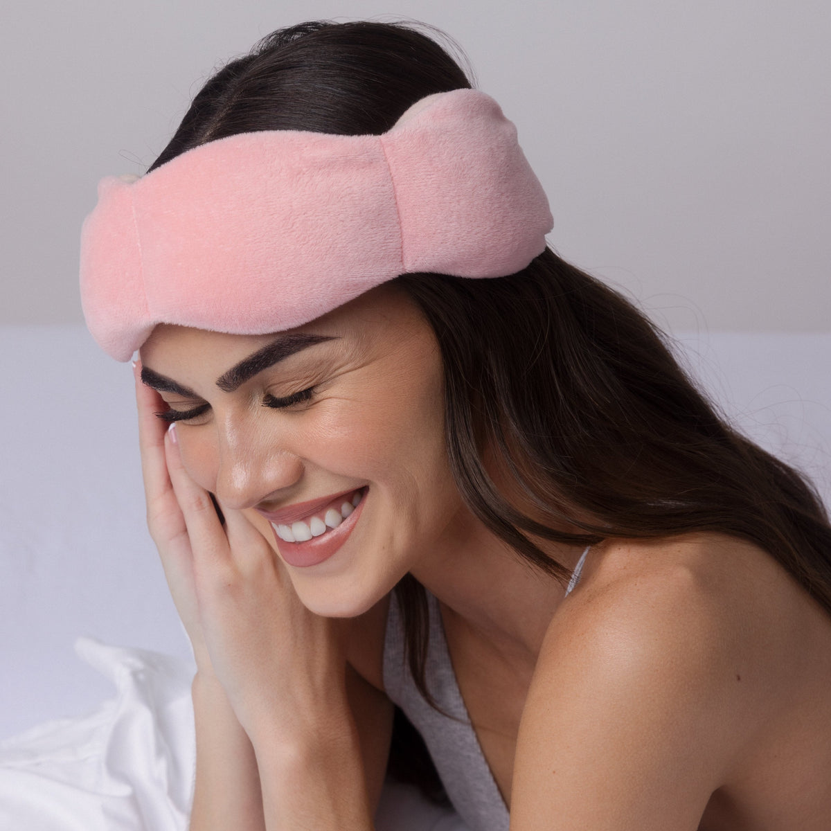 Nodpod weighted sleep mask in Blush Pink, worn while resting