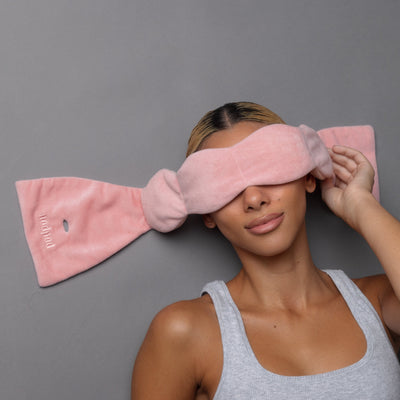 Nodpod weighted sleep mask in Blush Pink, on a person sleeping