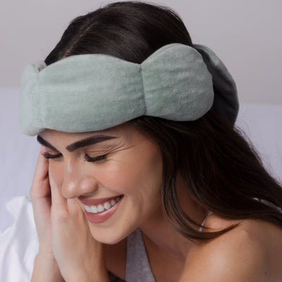 Man side-sleeping comfortably with Nodpod weighted sleep mask remaining securely in place