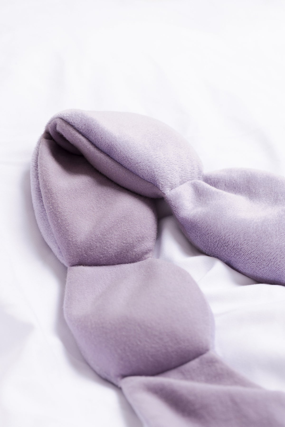 Nodpod weighted sleep mask displaying strap-free design and even weight distribution
