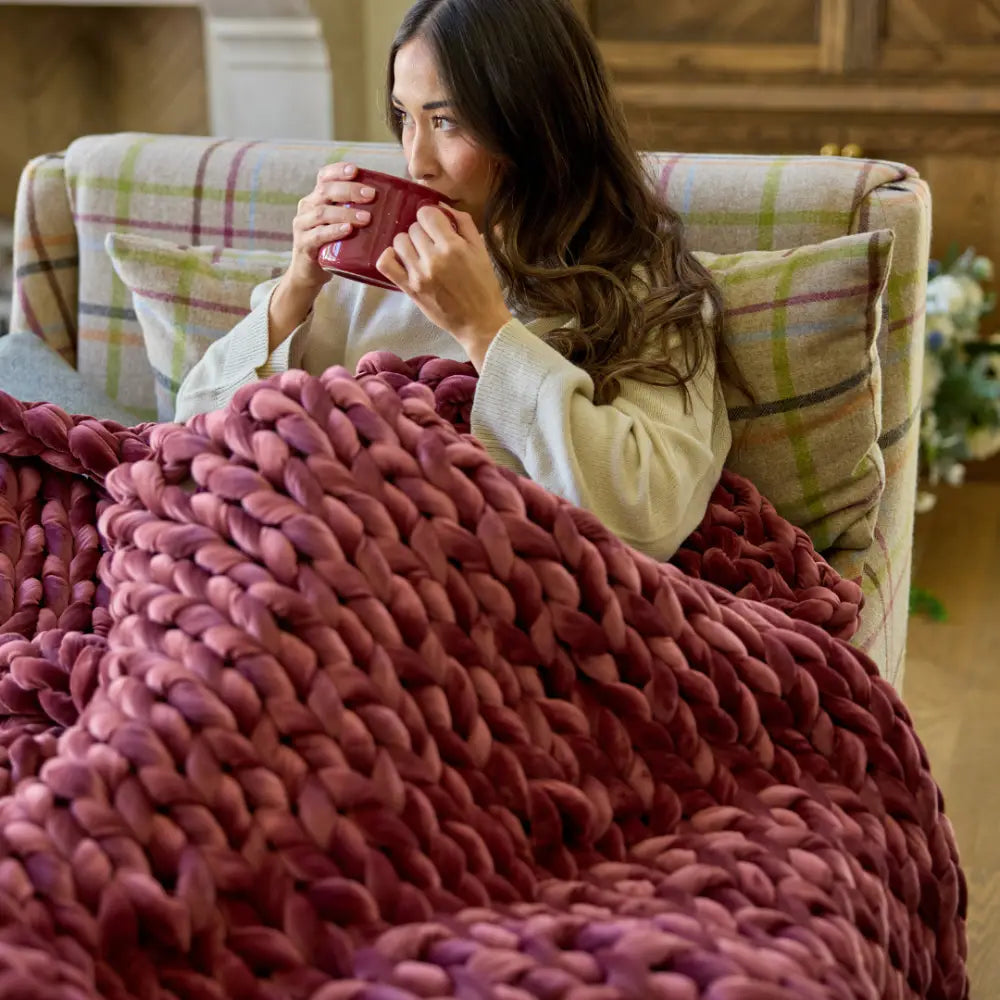Nuzzie chunky hand-knit velvet weighted blanket in deep ruby red color