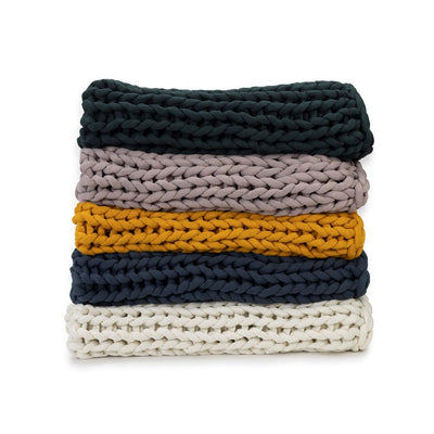 Nuzzie knit weighted blanket, shown in five colors
