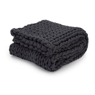 Nuzzie chunky knit weighted blanket in charcoal gray folded into compact neat square