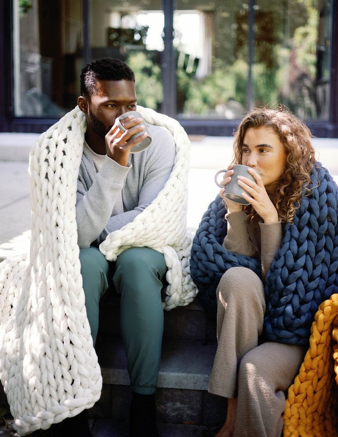Nuzzie knit weighted blanket in Cream, used outdoors