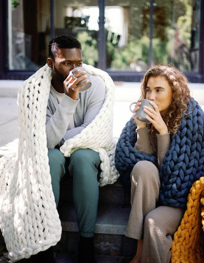 Nuzzie knit weighted blanket in Cream, used outdoors