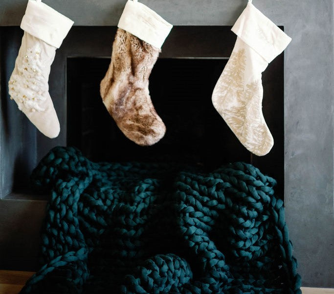 Nuzzie knit weighted blanket in Forest Green, in a holiday setting