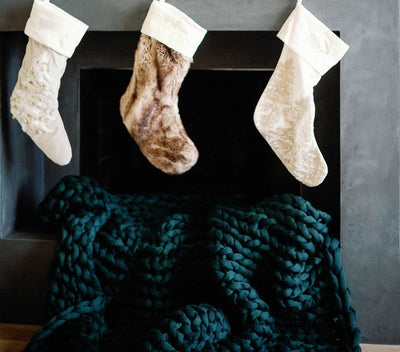 Nuzzie knit weighted blanket in Forest Green, in a holiday setting
