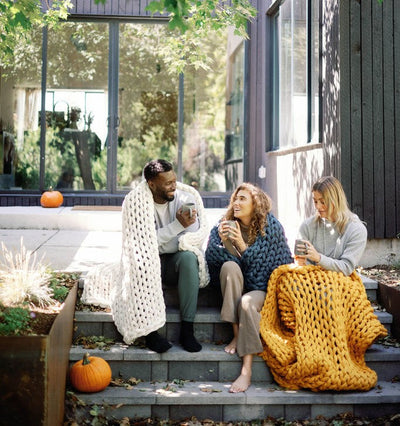 Nuzzie knit weighted blanket in Marigold, shared by friends