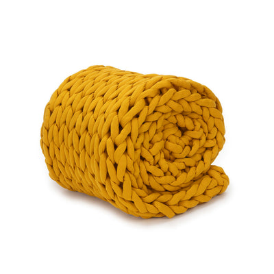 Nuzzie knit weighted blanket in Marigold, rolled up