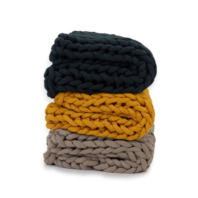 Nuzzie knit weighted blanket, shown in multiple colors