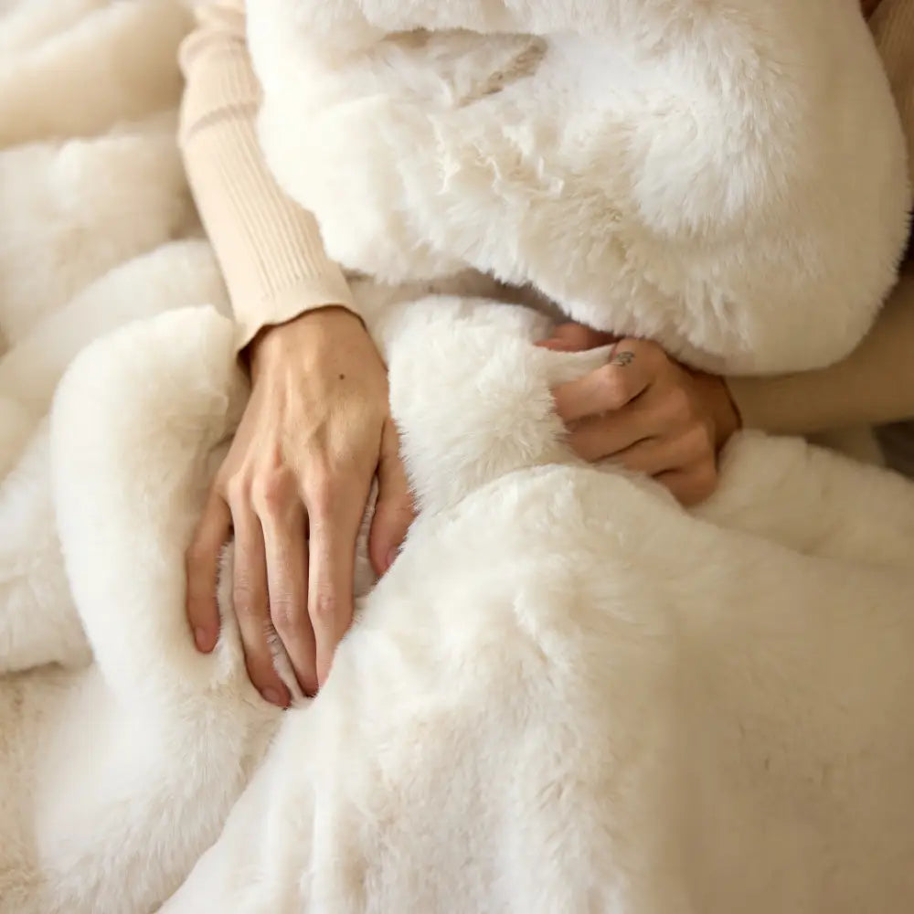 Nuzzie Snuggle Luxe chunky hand-knit blanket in warm vanilla cream color