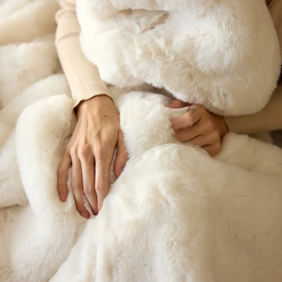 Nuzzie Snuggle Luxe chunky hand-knit blanket in warm vanilla cream color