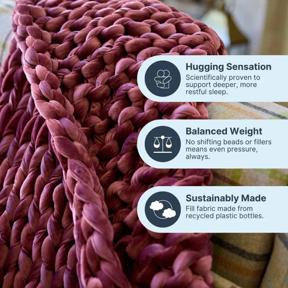 Person relaxing on couch beneath calming deep touch pressure of Nuzzie ruby velvet blanket