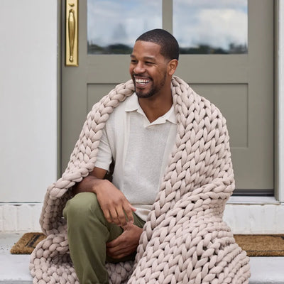 Person sleeping comfortably under cooling Nuzzie Ice Knit weighted blanket in coastal sand