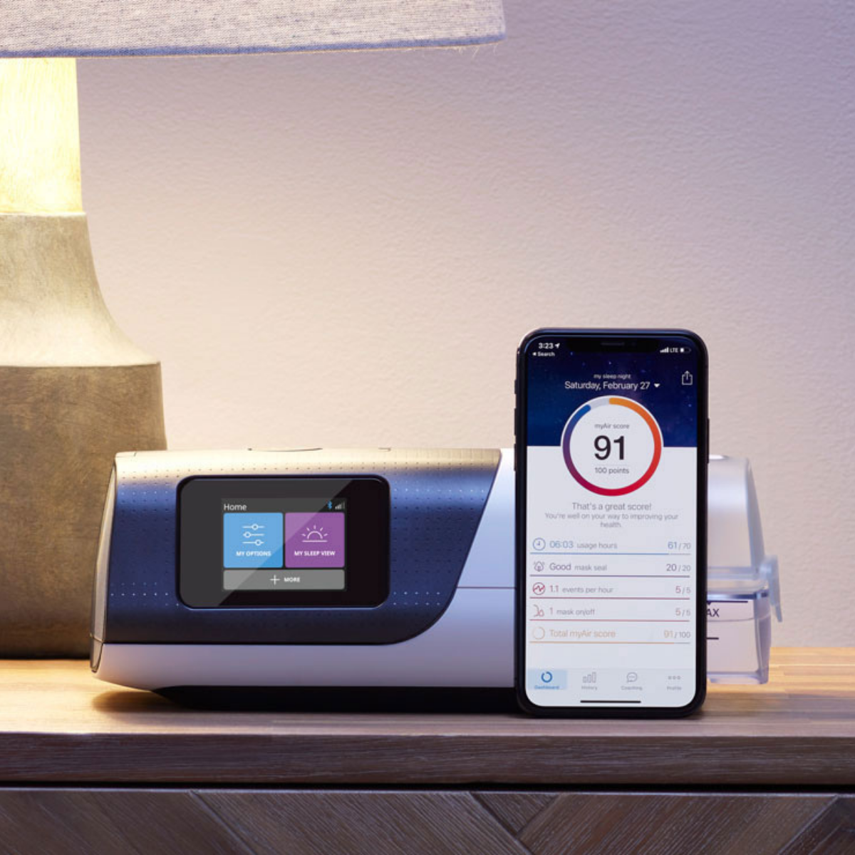Refurbished ResMed AirSense 11 AutoSet APAP machine resting on nightstand next to myAir app