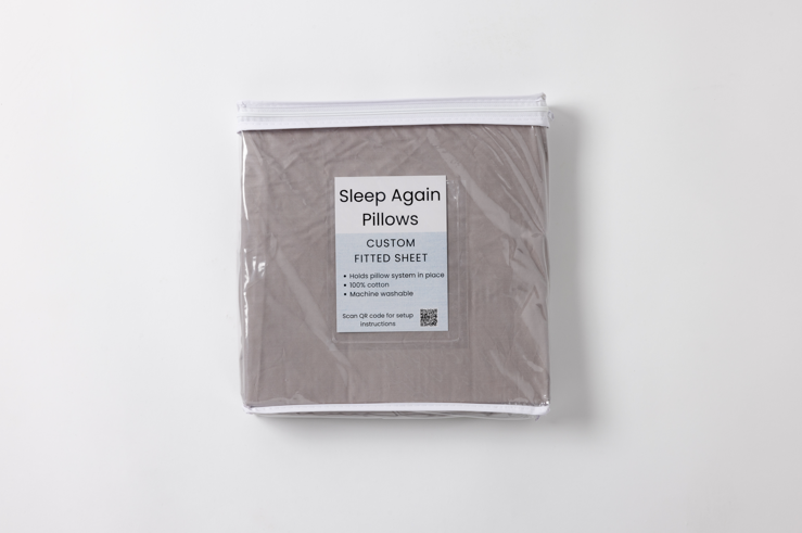 Custom-tailored fitted sheet designed to lock Sleep Again Pillow System wedges into position