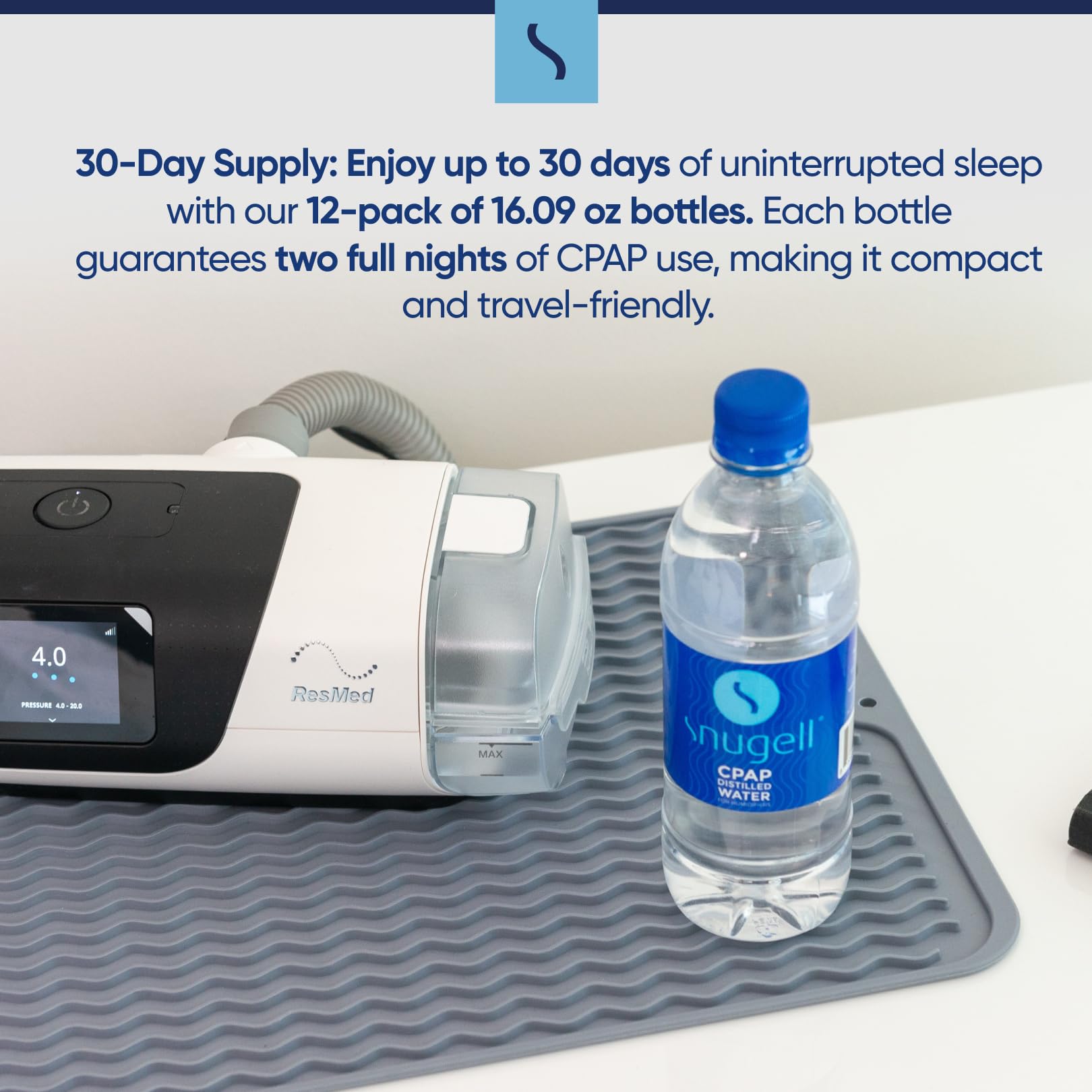 CPAP machine with a bottle of Snugell CPAP water on a white surface