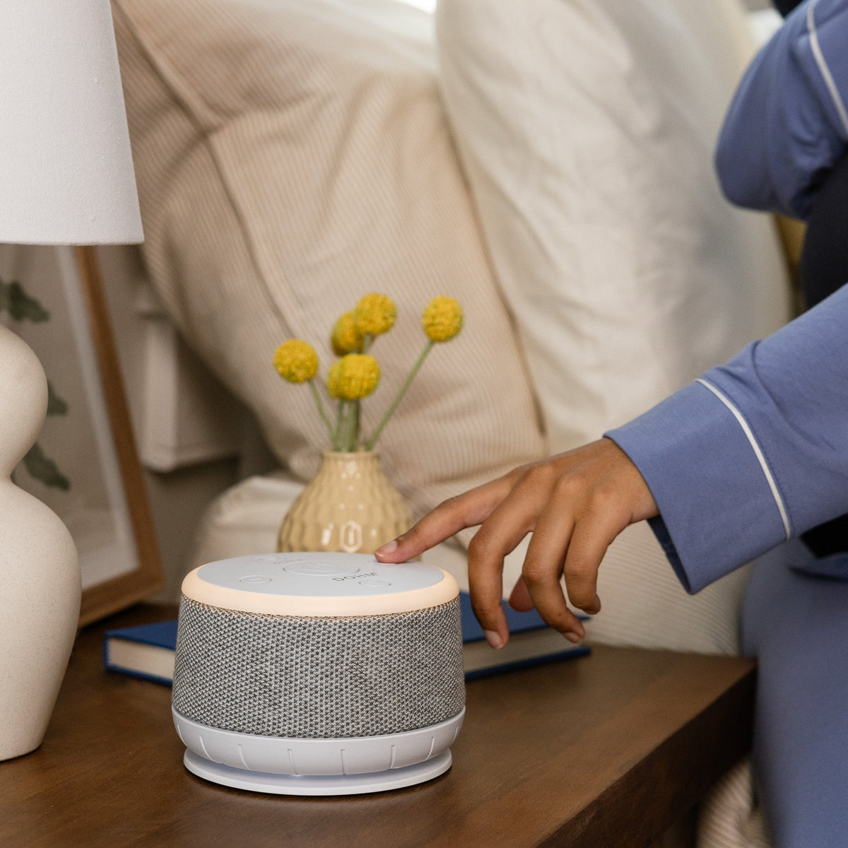 Yogasleep Dohm Nova sound machine creating relaxing ambient sound in modern bedroom setting