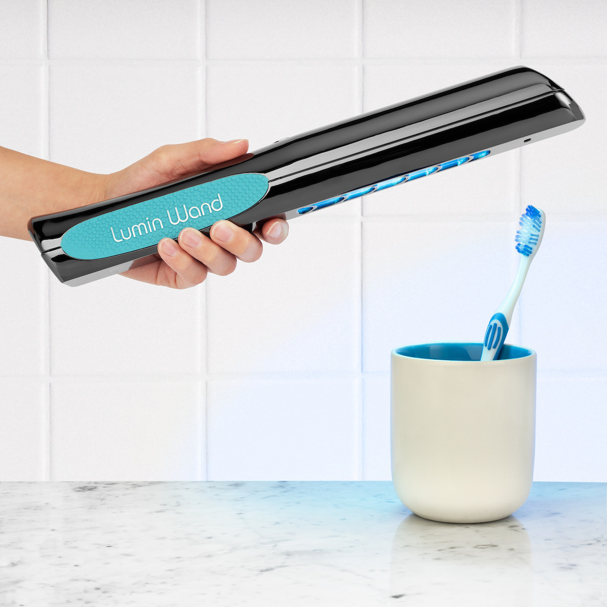 Lumin Wand portable UV light sanitizer disinfecting toothbrushes in bathroom setting